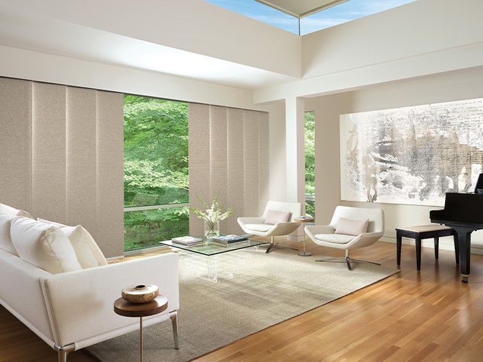 Living room with large windows featuring Skyline® Gliding Window Panels Fabric; Yorkshire  Color: Earl Grey